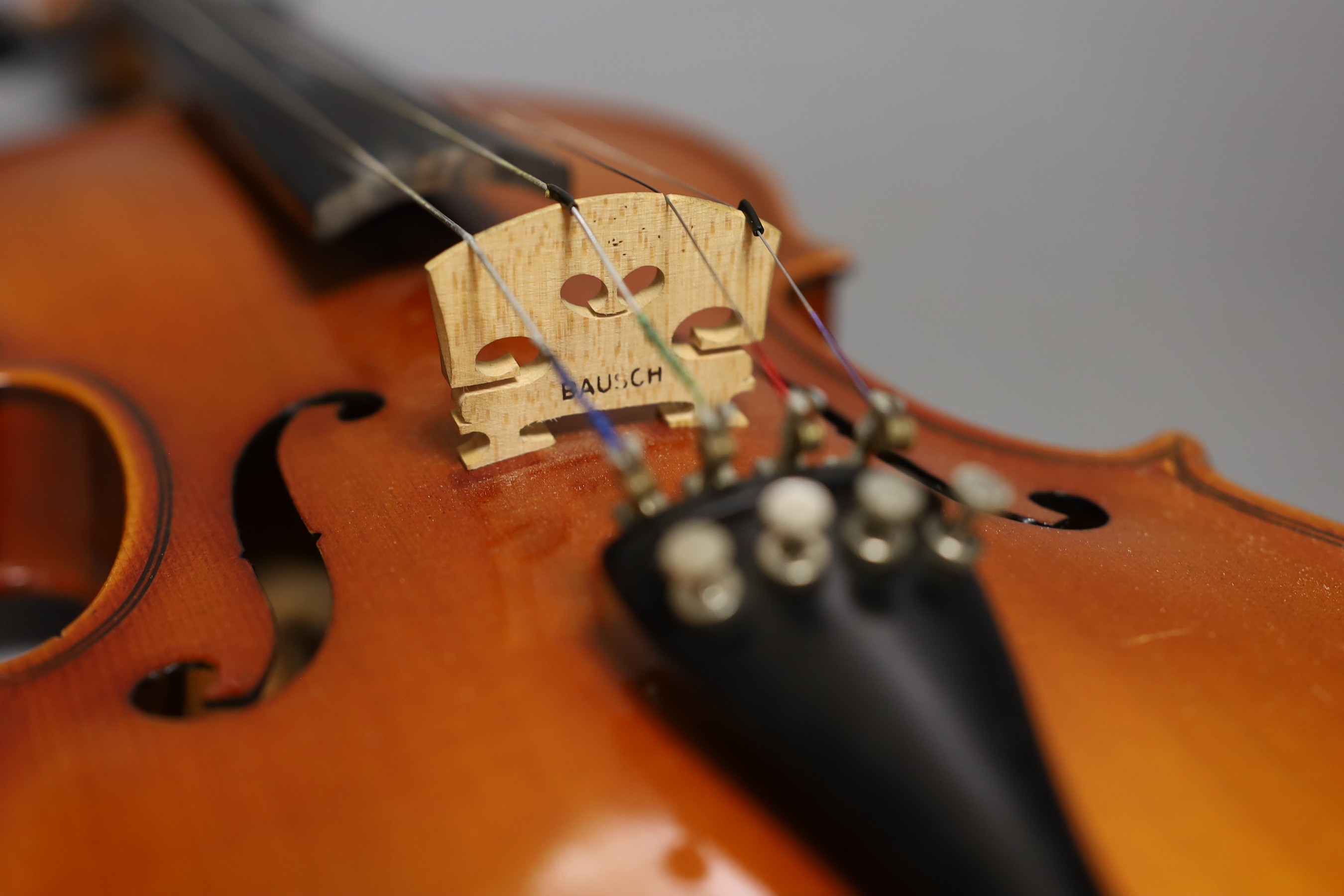 A cased child's violin and bow with ivorine tip, violin 55cms long